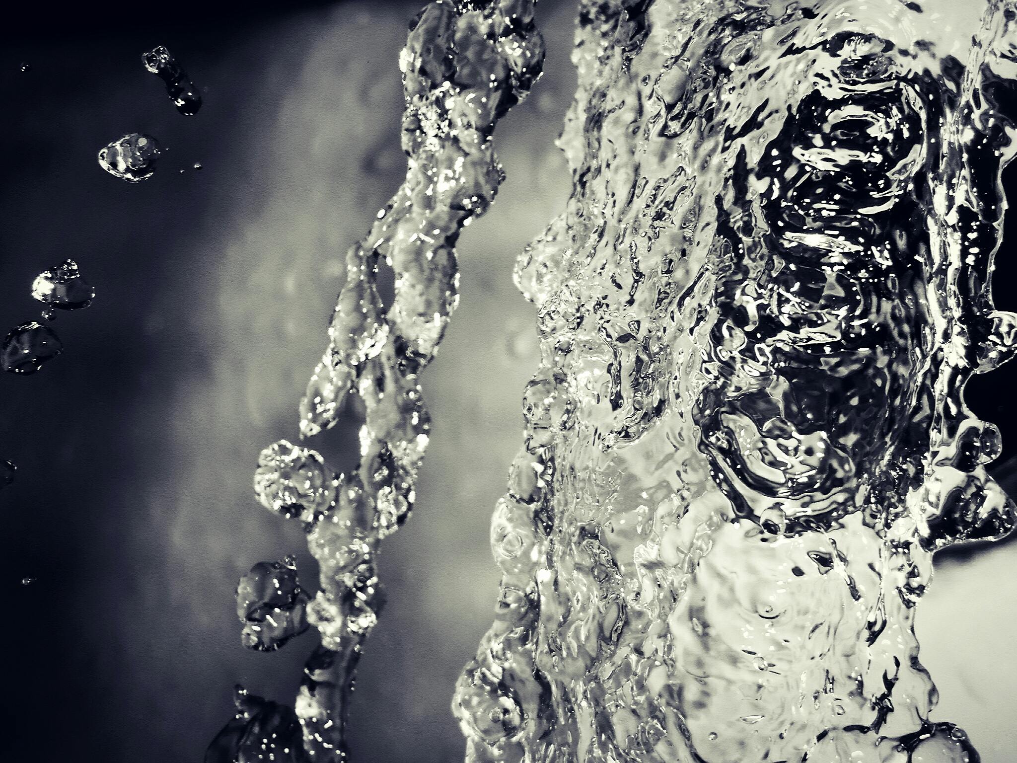 Close-up of water splashing in motion, showcasing dynamic fluidity and texture.